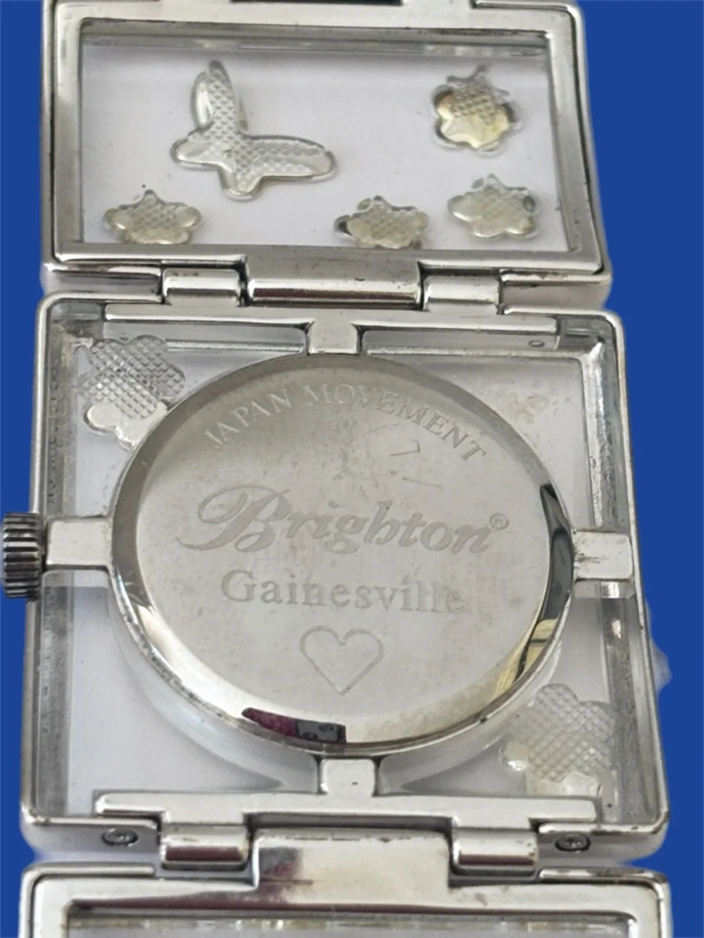 Brighton Gainesville watch features a design silver-tone butterflies & flowers.